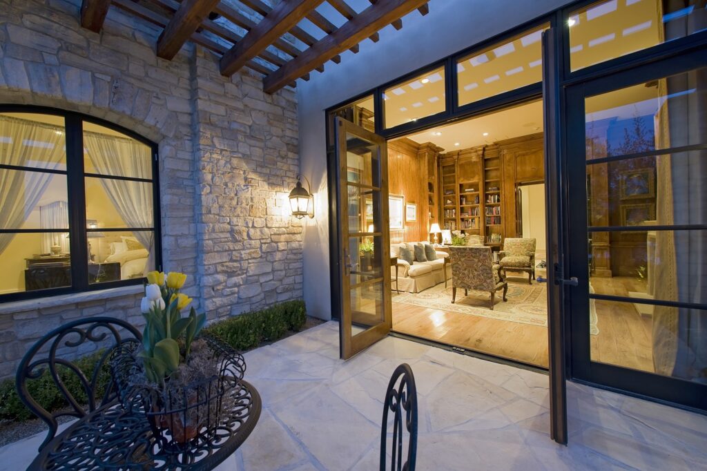 open patio doors leading out to tiled patio, with a peak into an elegant living room