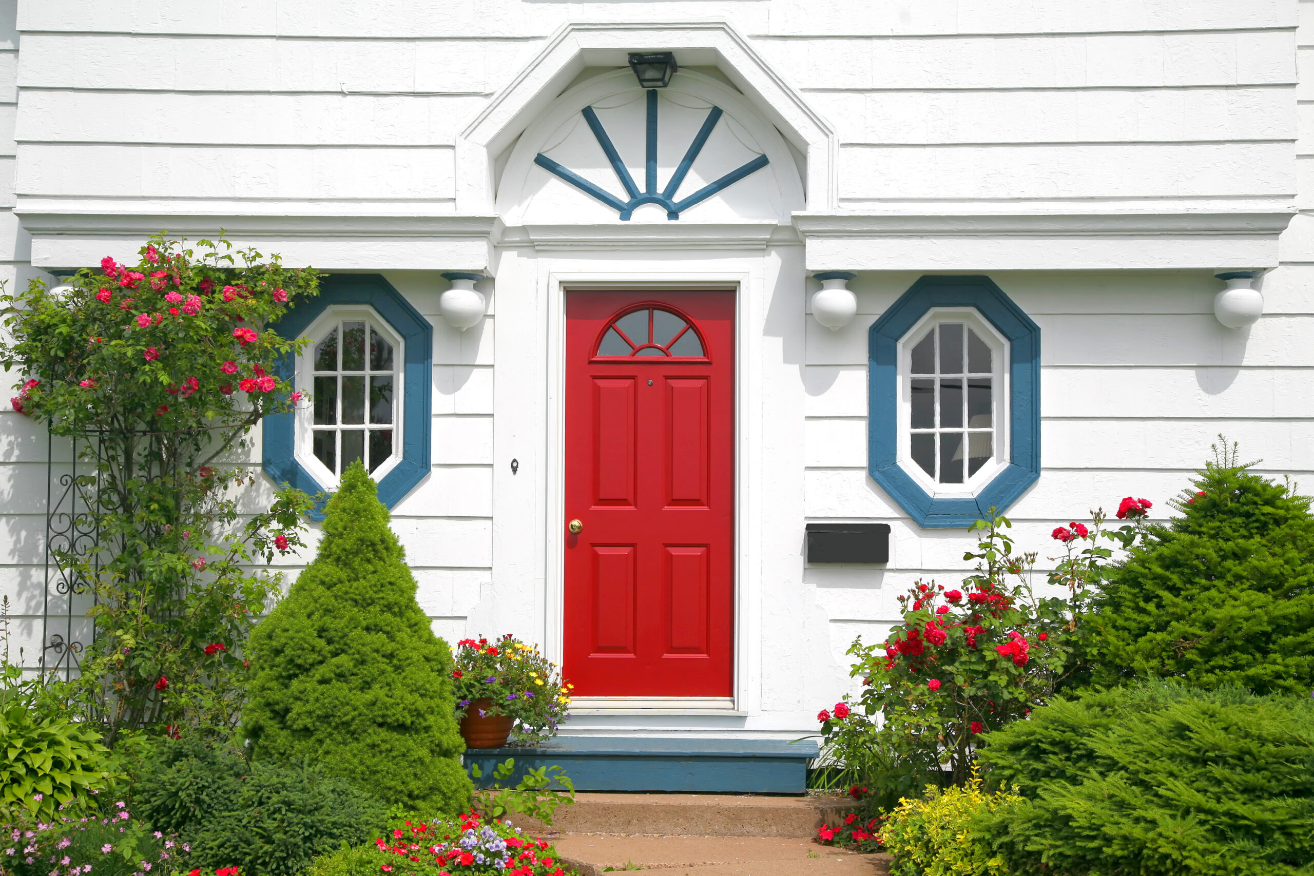 A bright red door on the entrance of a home.