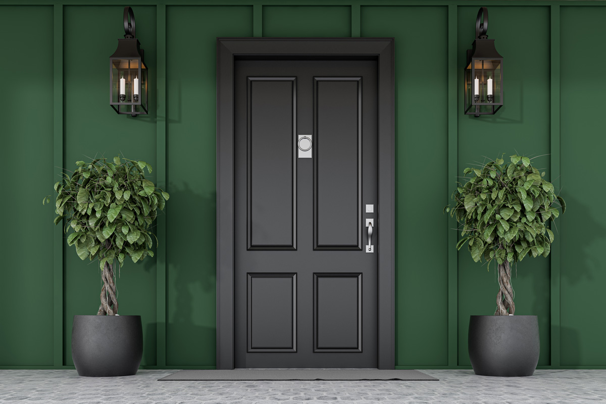 A black exterior door on an emerald green home in El Paso.