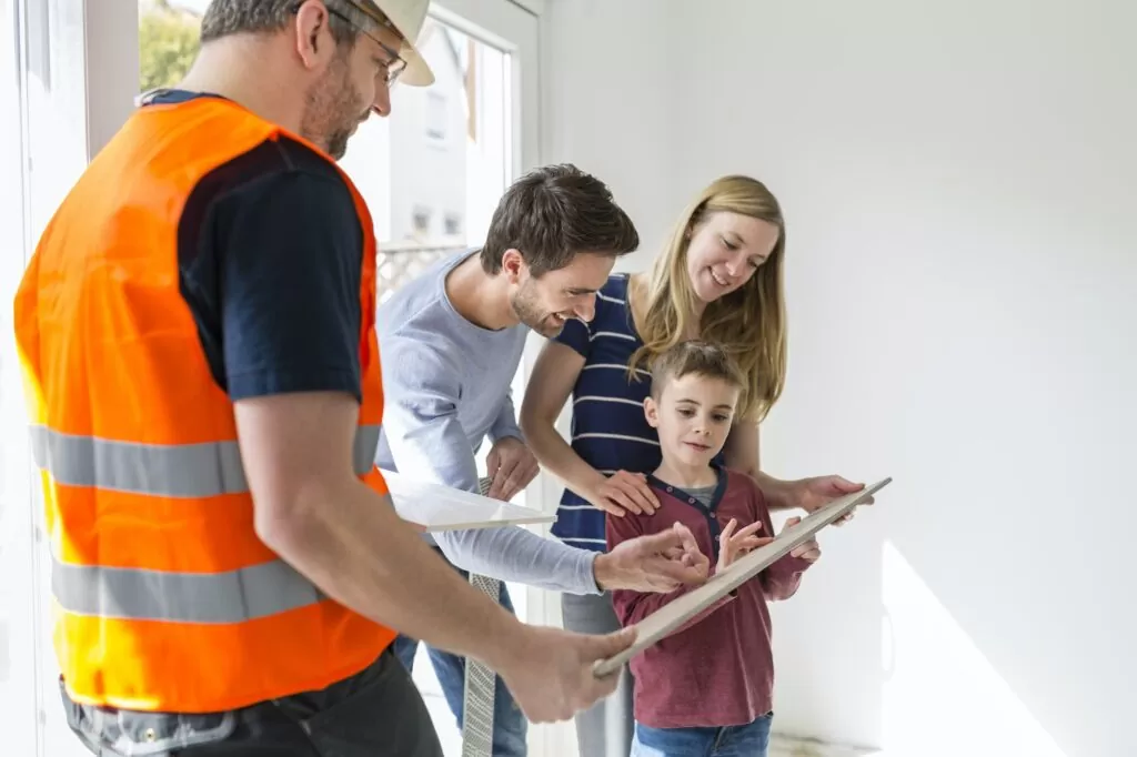 Construction worker showing family tile samples
